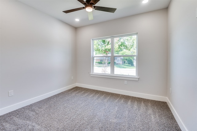 carpeted spare room featuring ceiling fan