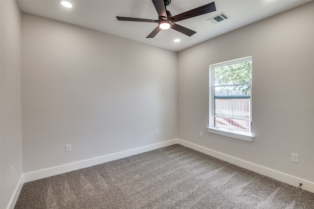 spare room with ceiling fan and carpet