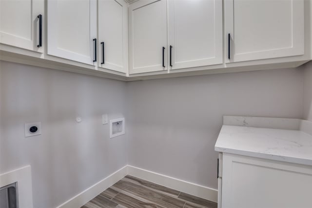 laundry area with washer hookup, wood-type flooring, gas dryer hookup, cabinets, and electric dryer hookup