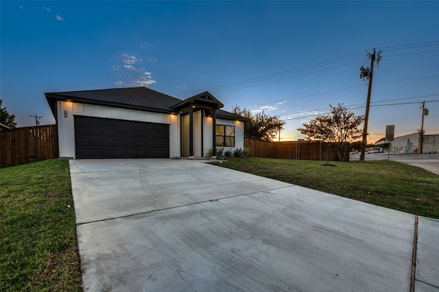 view of front facade featuring a garage and a yard