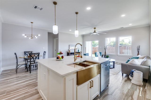 kitchen with crown molding, a center island with sink, decorative light fixtures, stainless steel dishwasher, and white cabinetry