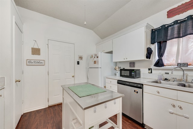 kitchen featuring sink, stainless steel dishwasher, dark hardwood / wood-style floors, and white refrigerator