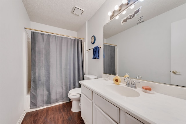 full bathroom with toilet, vanity, hardwood / wood-style flooring, a textured ceiling, and shower / bathtub combination with curtain