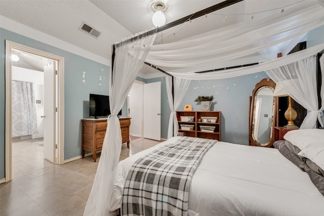 bedroom featuring a textured ceiling and light tile patterned flooring