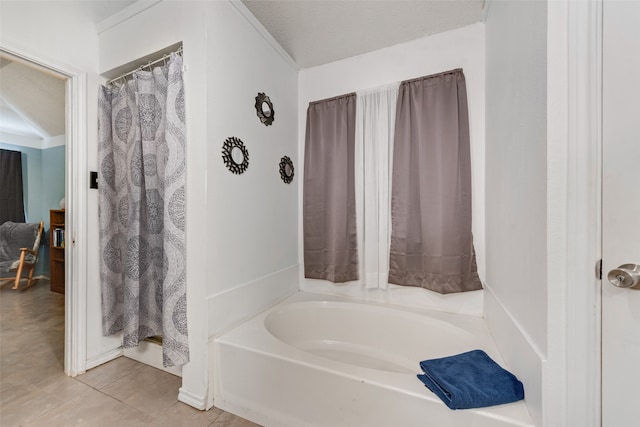 bathroom featuring a textured ceiling, separate shower and tub, and tile patterned floors