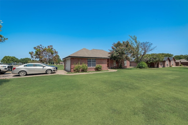 201 Anita Ln, Waxahachie, TX 75165 - view of front facade with brick siding, a front yard, an attached garage, and concrete driveway