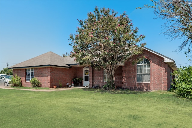 ranch-style home featuring a front yard