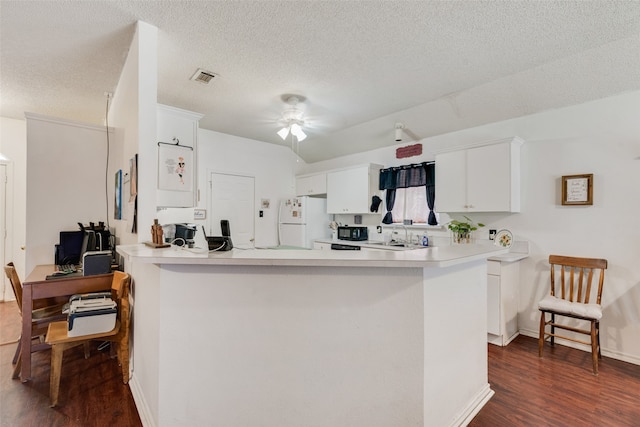 kitchen featuring white cabinetry, dark hardwood / wood-style floors, kitchen peninsula, ceiling fan, and white refrigerator