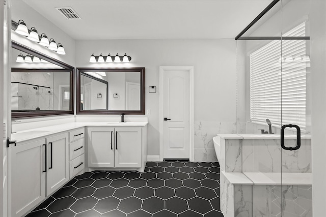 bathroom featuring independent shower and bath, vanity, tile patterned flooring, and a healthy amount of sunlight