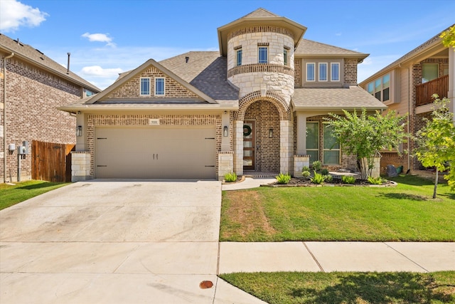 view of front of property with a front yard and a garage