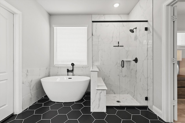 bathroom featuring tile walls, plus walk in shower, and tile patterned floors