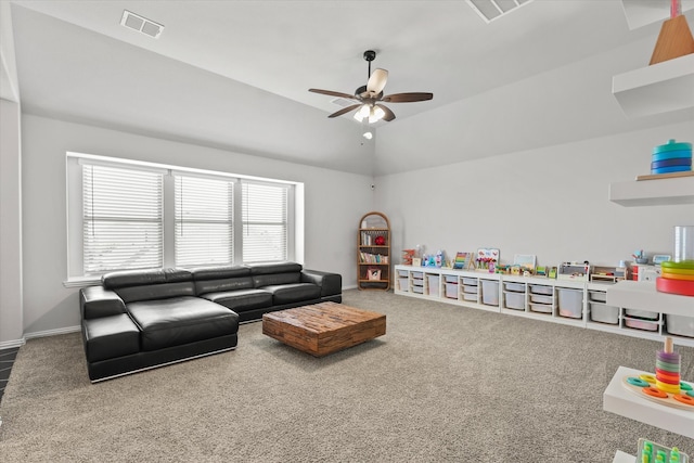 living room with lofted ceiling, ceiling fan, and carpet flooring