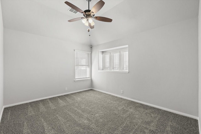 carpeted spare room featuring vaulted ceiling and ceiling fan