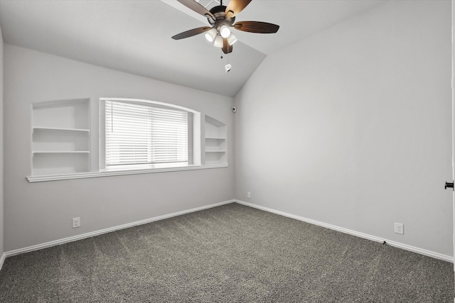 carpeted spare room featuring vaulted ceiling, ceiling fan, and built in features