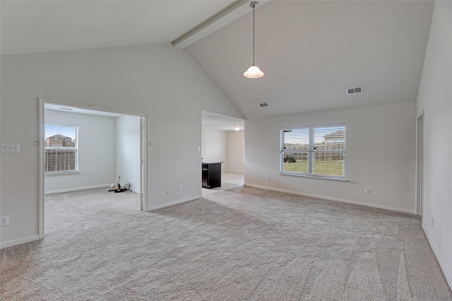 unfurnished living room featuring beam ceiling, high vaulted ceiling, and light colored carpet