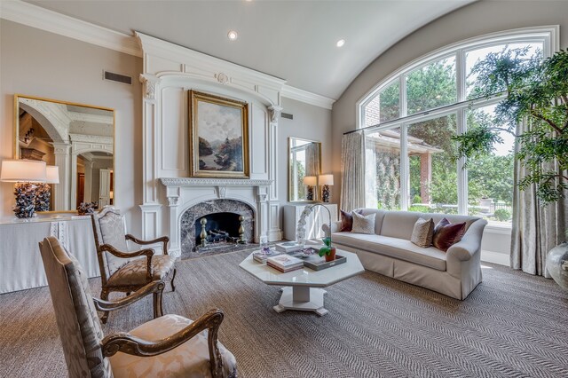 carpeted living room featuring high vaulted ceiling, crown molding, and a high end fireplace