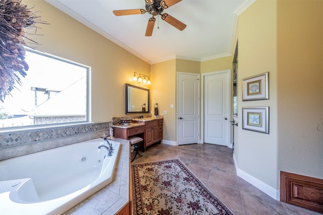 bathroom with tiled tub, ornamental molding, vanity, tile patterned floors, and ceiling fan