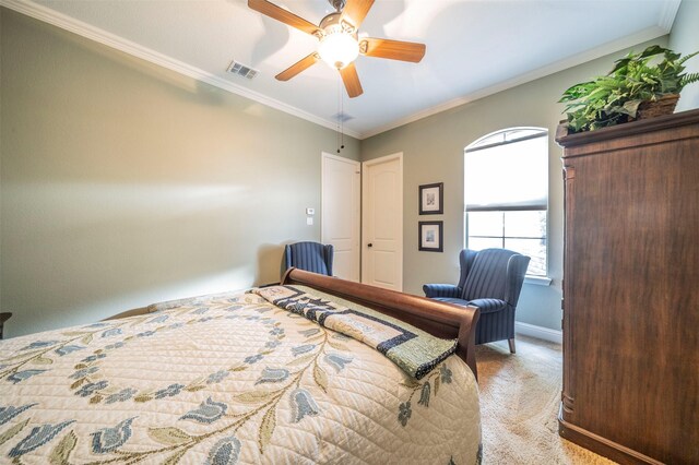 carpeted bedroom with ceiling fan and ornamental molding