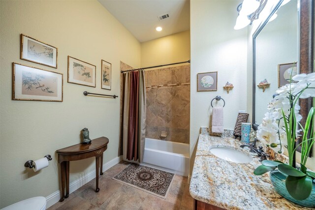 full bathroom featuring shower / tub combo with curtain, toilet, vanity, and tile patterned floors