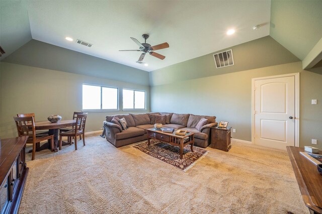 carpeted living room with ceiling fan and lofted ceiling