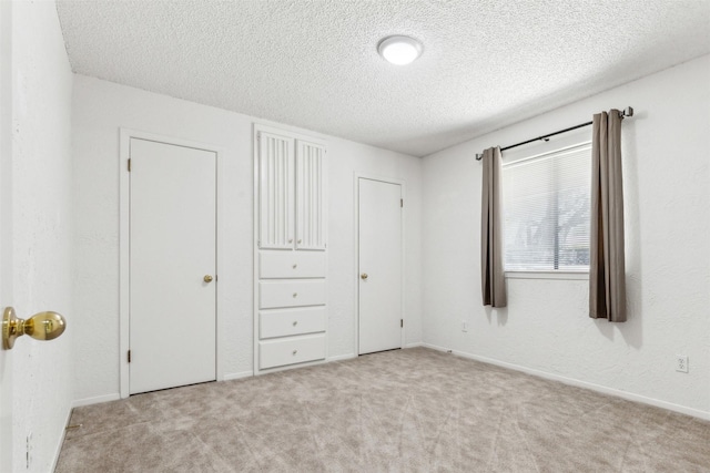 unfurnished bedroom with carpet floors and a textured ceiling