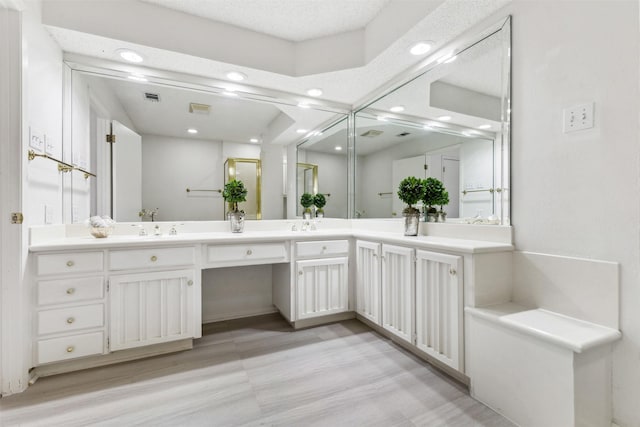 full bathroom featuring double vanity, visible vents, a sink, and recessed lighting