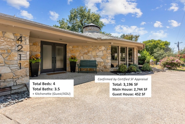 view of exterior entry featuring french doors and a patio