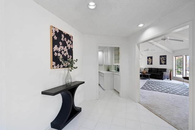 corridor featuring light carpet, a textured ceiling, and recessed lighting