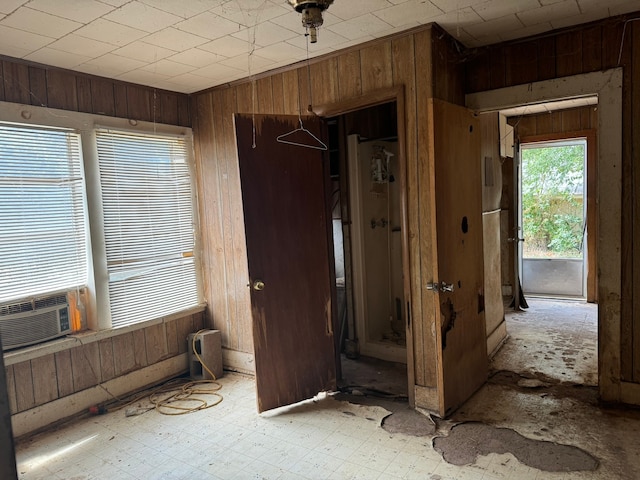 interior space featuring wooden walls and cooling unit