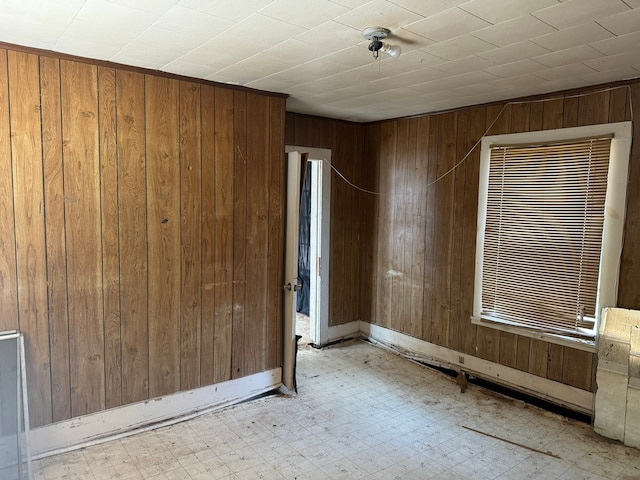 spare room with wood walls and light tile patterned floors