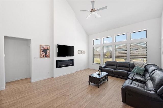 living room featuring high vaulted ceiling, light hardwood / wood-style floors, and ceiling fan