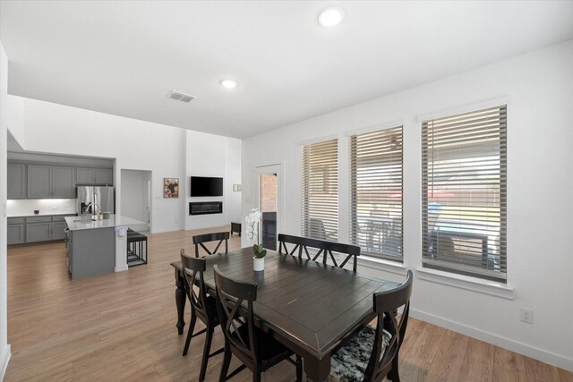 entrance foyer with french doors, light hardwood / wood-style flooring, and a high ceiling