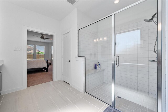 carpeted bedroom with ceiling fan and ensuite bath