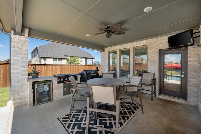 view of patio / terrace featuring beverage cooler, area for grilling, and ceiling fan