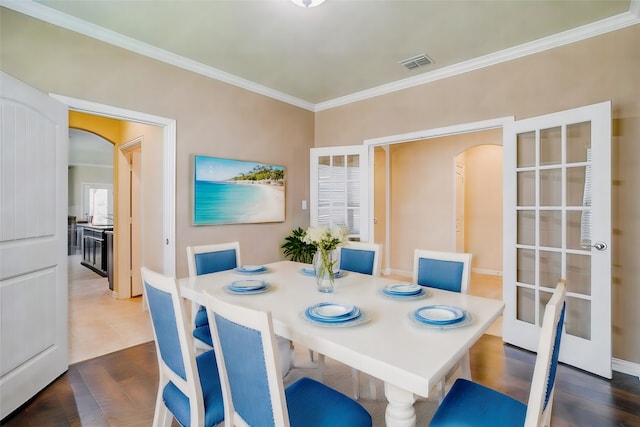 dining room with ornamental molding and wood-type flooring