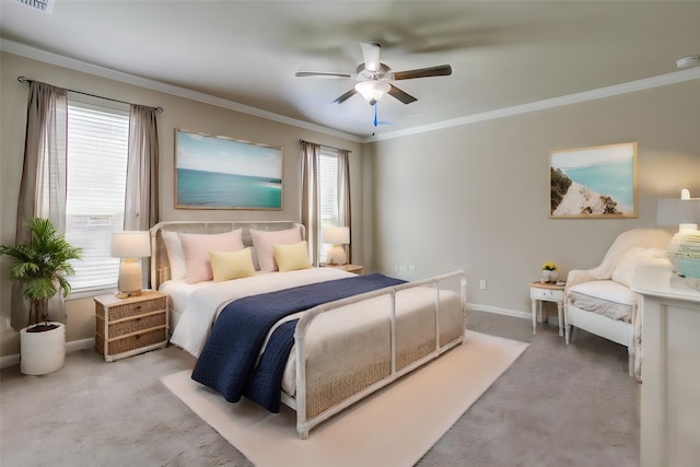 carpeted bedroom featuring ceiling fan and crown molding