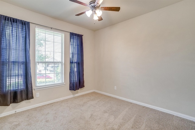 carpeted empty room featuring ceiling fan and a healthy amount of sunlight