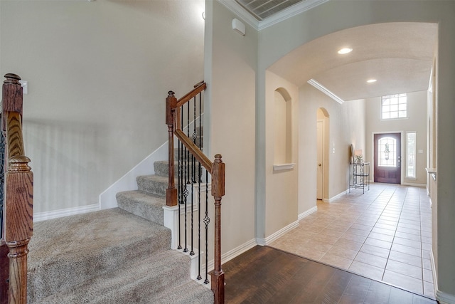 foyer entrance featuring ornamental molding and hardwood / wood-style flooring