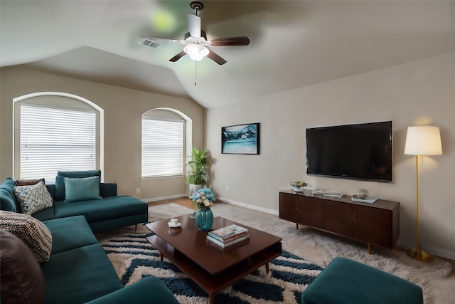 living room featuring ceiling fan, vaulted ceiling, and light carpet