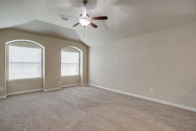 carpeted empty room with ceiling fan and lofted ceiling