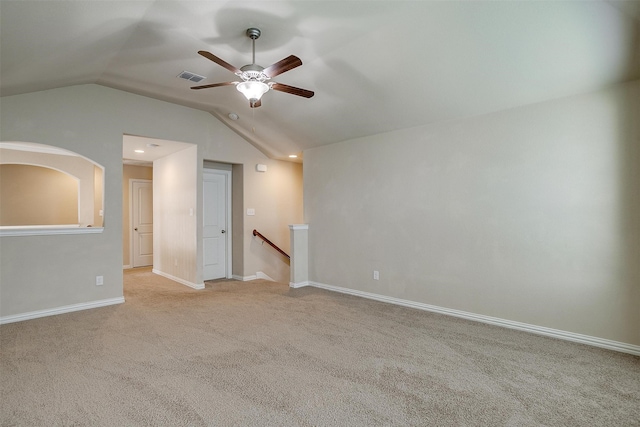 carpeted empty room with ceiling fan and lofted ceiling