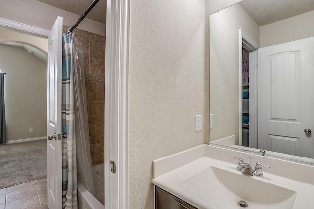 bathroom featuring tile patterned floors, vanity, and shower / tub combo with curtain