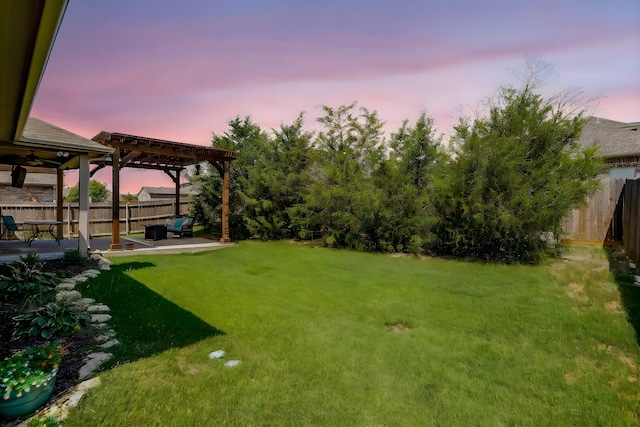 yard at dusk with a pergola and a patio