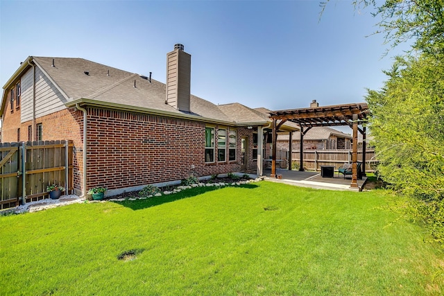 rear view of property with a patio, a yard, and a pergola