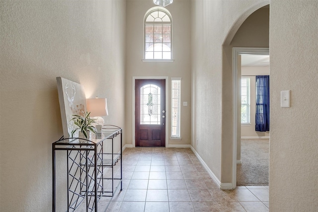 tiled foyer with a high ceiling