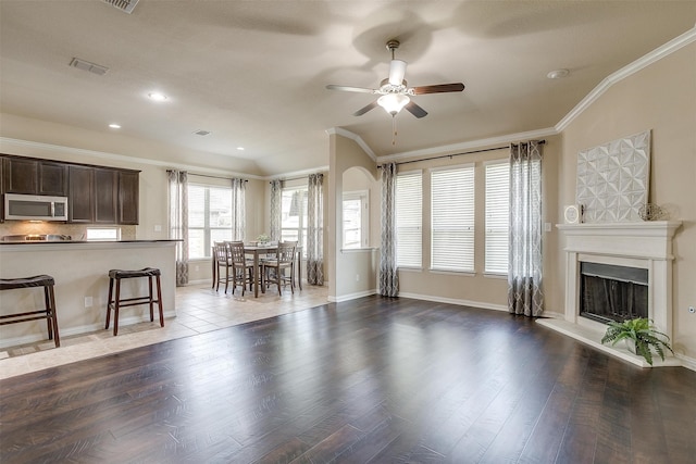 unfurnished living room featuring ceiling fan, crown molding, tile patterned flooring, and lofted ceiling