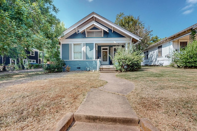 view of front facade with a front yard and a porch