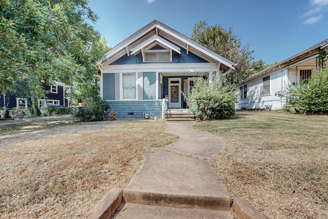 view of front of property with a porch and a front yard