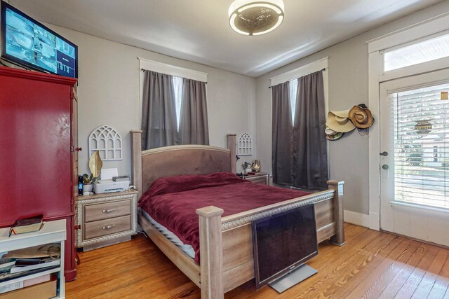 bedroom featuring multiple windows and light hardwood / wood-style floors