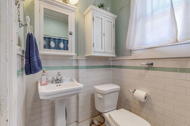 bathroom with tile walls, decorative backsplash, and toilet